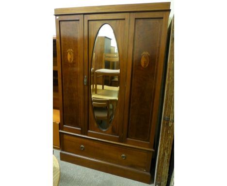 An Edwardian inlaid mahogany wardrobe with central mirrored door and single drawer platform base. 124cm wide