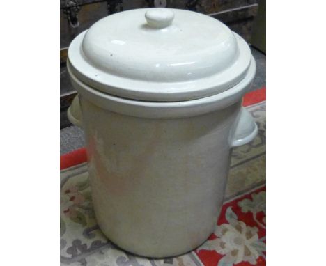 A glazed ceramic jar with outlet and cover