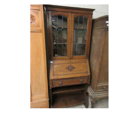 EARLY 20TH CENTURY OAK FRAMED BUREAU BOOKCASE WITH TWO LEADED AND GLAZED DOORS THE DROP FRONT WITH SINGLE DRAWER WITH OPEN SH