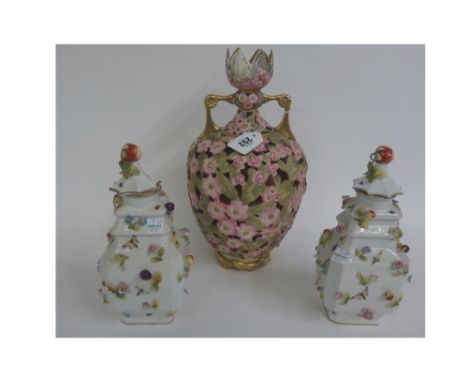 A Rudolstadt porcelain reticulated two handled baluster vase, decorated with pink flowers and leaves, 33cm high and a pair of