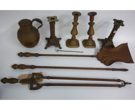 A set of three late Victorian brass fire tools, with ring turned finials, two pairs of Victorian brass candlesticks and a bra