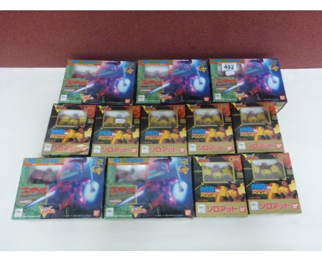 Seven boxed 1993 Bandai MS in Pocket 1/144 scale transformer style robot figures model 04 in yellow & red, plus Five boxed 19