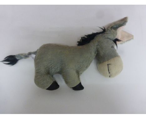 1966 Merrythought Eeyore the Donkey with registered design label to foot and detachable tail, approx 12" long by 9" tall