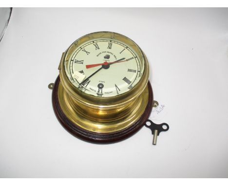 Brass Bulk Head Clock The Dial Marked Made For Royal Navy London, with key