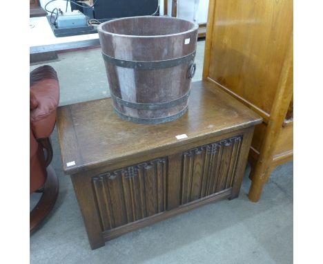 An oak linenfold panel blanket box and a brass banded log box 