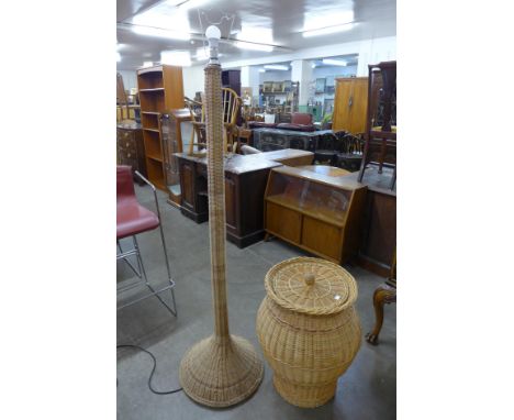 A wicker laundry basket and a floor standing lamp 