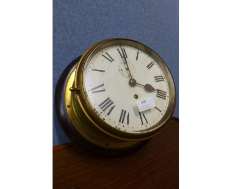 An early 20th Century brass cased circular ship's clock 