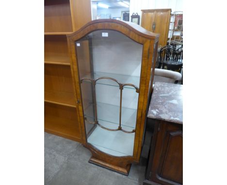 An Art Deco walnut single door display cabinet 