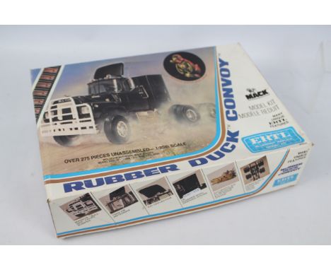 Ertl - A boxed Ertl 1:25 scale Mack Truck 'Rubber Duck' (from the film 'Convoy') plastic model kit. The kit has loose parts a