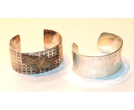 A plain polished bangle, stamped '1997 Tiffany &amp; Co 925'; and another with an applied butterfly motif, stamped 'Tiffany &
