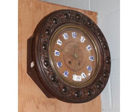 An oak wall clock with blue enamel chapters 