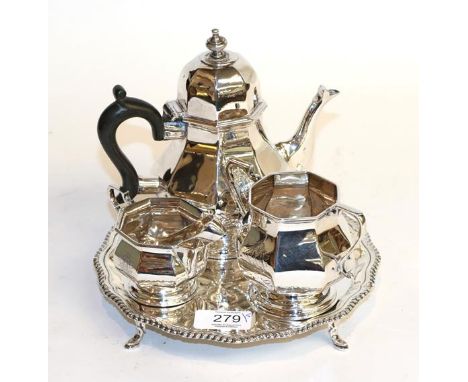 A three-piece Edward VII silver tea-service, by Henry Matthews, Birmingham, 1906, each piece octagonal and on spreading foot,
