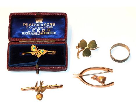 A 9 carat gold swallow bar brooch, length 4.2cm; a 9 carat gold shamrock brooch; a butterfly brooch, stamped '15', length 3.5