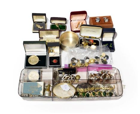 A travelling case of jewellery including various buttons including jet cameo and scarab buttons; an amber bead bracelet; a sc