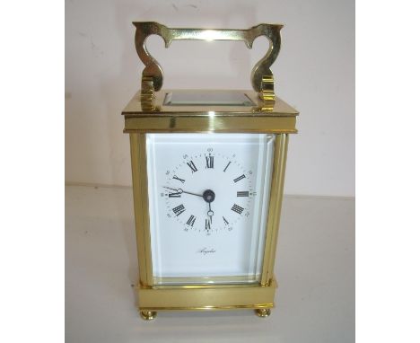 Quality modern brass cased bevelled edged glazed carriage clock marked Angelus 