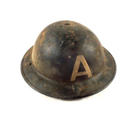 A WWII era tin helmet marked with an 'A'