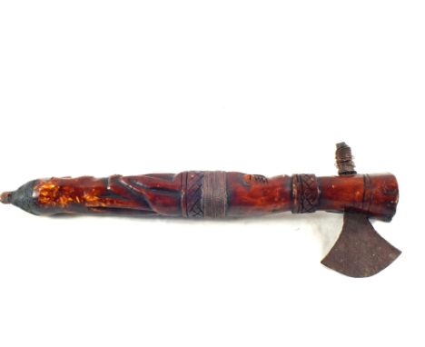 An ethnic carved hardwood axe with face and cross hatched decoration and metal bindings, length 14"