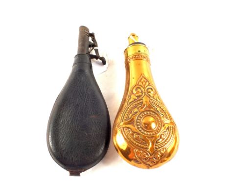 A vintage copper powder flask with a leather shot flask