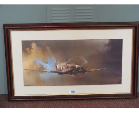 A print of a Spitfire, framed and glazed