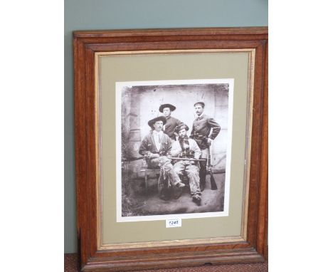 A print of a 'young' Buffalo Bill with three other western gentleman, mounted in a fine Oak frame and glazed