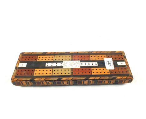 An inlaid wooden crib board with Masonic compass decoration
