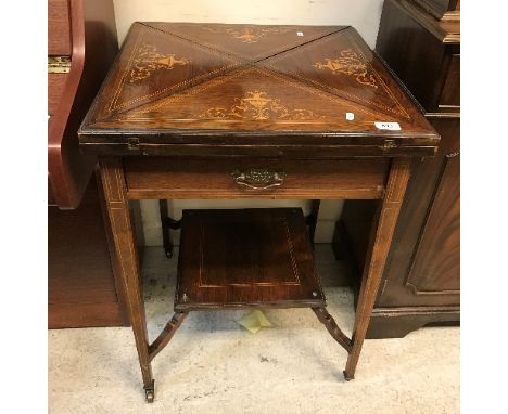 An Edwardian rosewood and marquetry inlaid envelope card table with single frieze drawer on square tapered legs united by an 