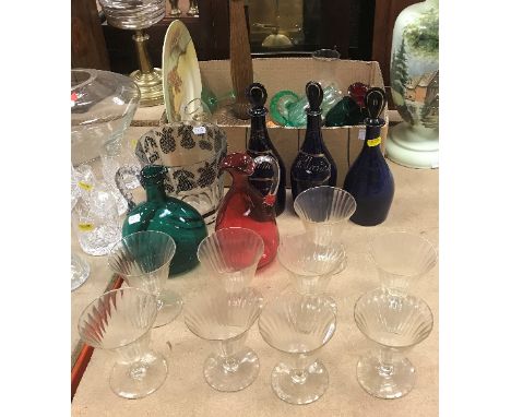 A collection of glassware to include three 19th Century Bristol blue decanters, one inscribed "Holland", another "Brandy", to