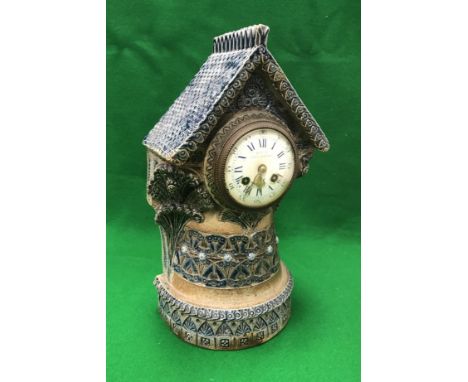 A Martin Brothers stoneware mantel clock by Robert Wallace Martin, the eight day movement with white enamel dial, the chapter