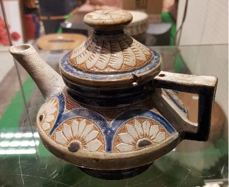 A Martin Brothers stoneware teapot of squat form by Robert Wallace Martin with floral decoration, inscribed "R W Martin  Sout