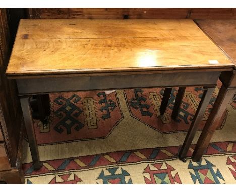 A George III mahogany fold over card table of rectangular form, the top with moulded edge above a plain frieze on square cham