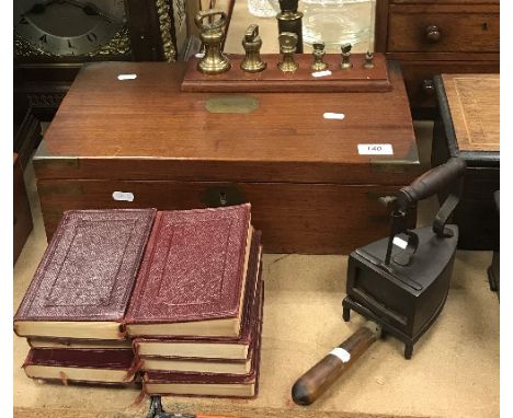 A Victorian mahogany writing slope with secret drawer to side (large split to top), together with a set of brass weights, a V