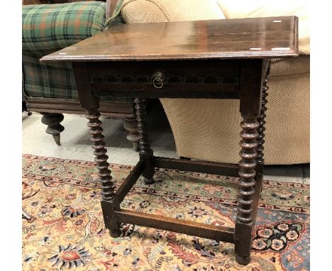 An oak single drawer side table in the 17th Century manner, raised on bobbin turned supports to blocks united by stretchers a