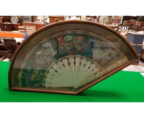 A Chinese ivory fan with hand-painted and ivory embellished panel of multi-figures in an interior with faces painted on ivory