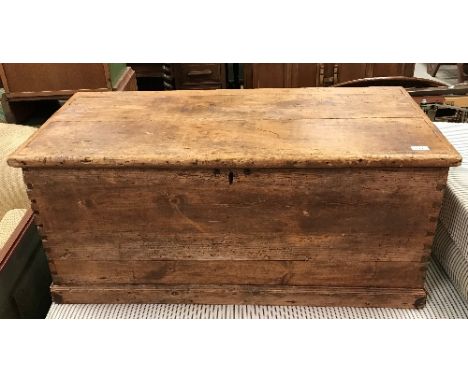 A Victorian pine trunk of plain form with iron carrying handles