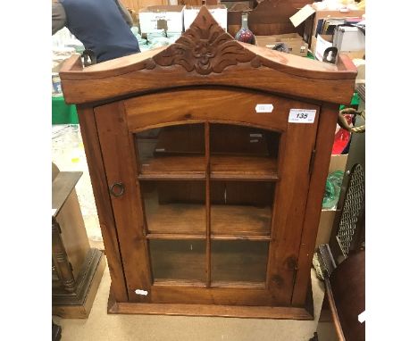 A modern hardwood wall cabinet with single glazed door, together with a small mahogany wall shelf