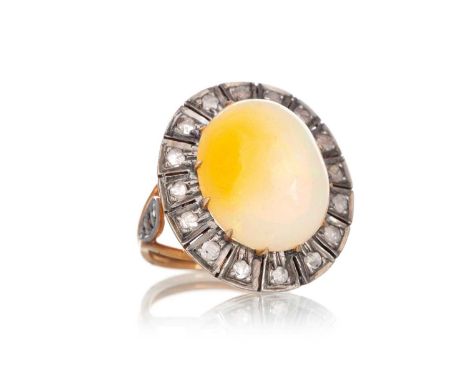 OPAL AND DIAMOND RING, set with a cabochon Ethiopian opal within a diamond halo, gold and silver, size LQty: 5.9g