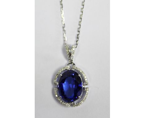  A Tanzanite and Diamond Pendant centred with an oval tanzanite weighing 8.50ct surrounded by a border and bail micro paved w