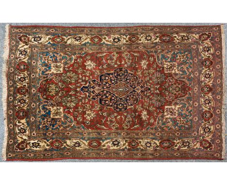  An Ishfahan Carpet Persia, central dark blue medallion, on a red and blue field, decorated in stylised leaf and floral motif