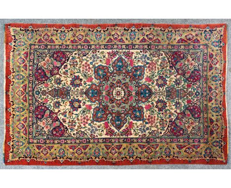  A Tabriz Carpet North West Persia, cream field, central blue and red floral star medallion, flowering buds and leaves throug