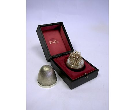  A Cased Silver-Gilt And Enamel Surprise Egg, Stuart Devlin, London, 1977 opens to reveal stylised gilt foliage with pearl de