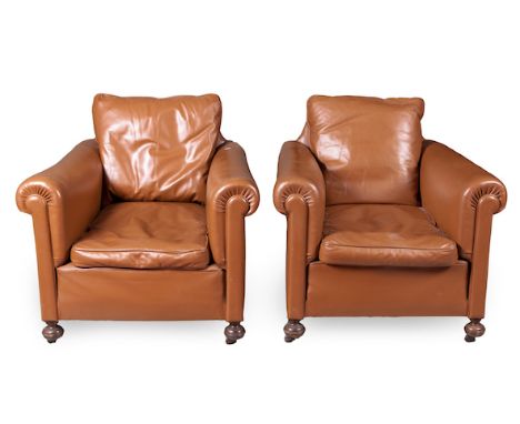  A Pair of Vintage Cognac Leather Library Armchairs  barrel arms, stuff-over seat on front turned feet, set upon castors  2 