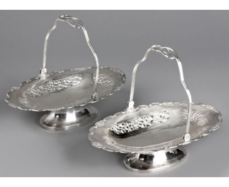  A Pair Of Chinese Silver Baskets, 20th Century each pierced oval body with a C-scroll and flowerhead rim, four pierced carto