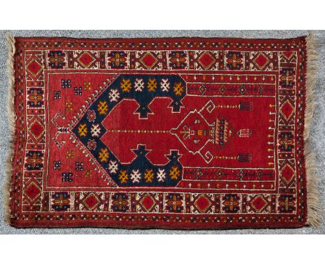  An Afghan Rug Red field, stylised architectural arch with chandelier, border with geometric lozenges and single guardstripe 