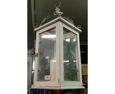 A painted wood framed candle lantern with wrought metal mounts.