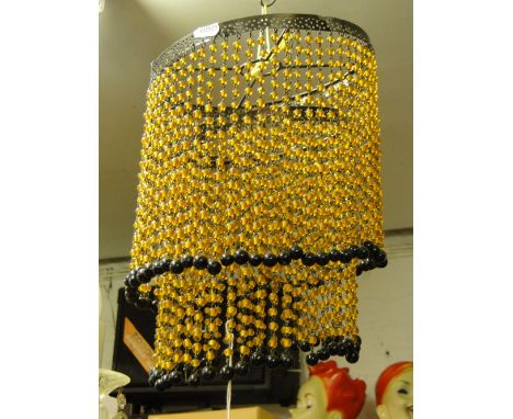A 2-tier beaded ceiling light fitting.