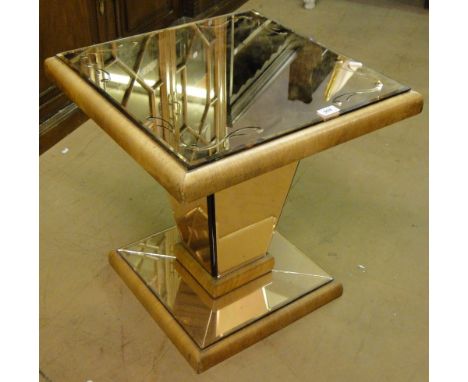 An Art Deco walnut coffee table with peach glass mirrored top.