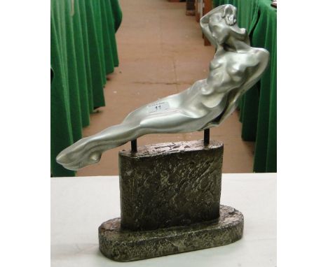 An Art Deco style metal figure of a reclining nude lady on plinth.