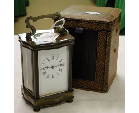Antique brass carriage clock of serpentine form with original leather case.