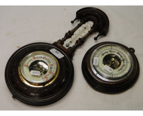 Antique wall barometer in carved wood case, with thermometer and a small circular barometer.