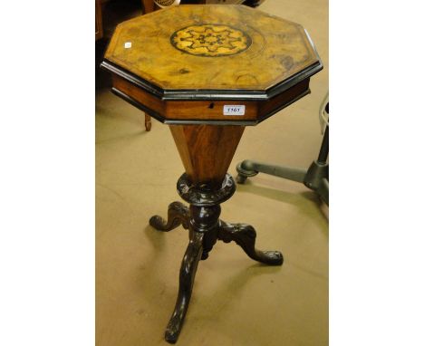 A Victorian walnut trumpet work box on tripod legs